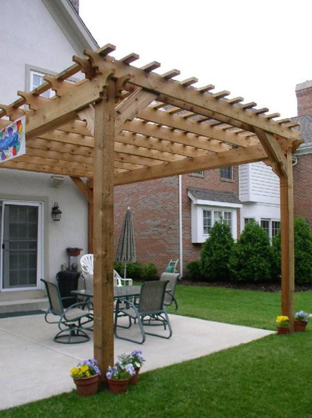 Inspiration for a large rustic back patio in Houston with stamped concrete and a pergola.