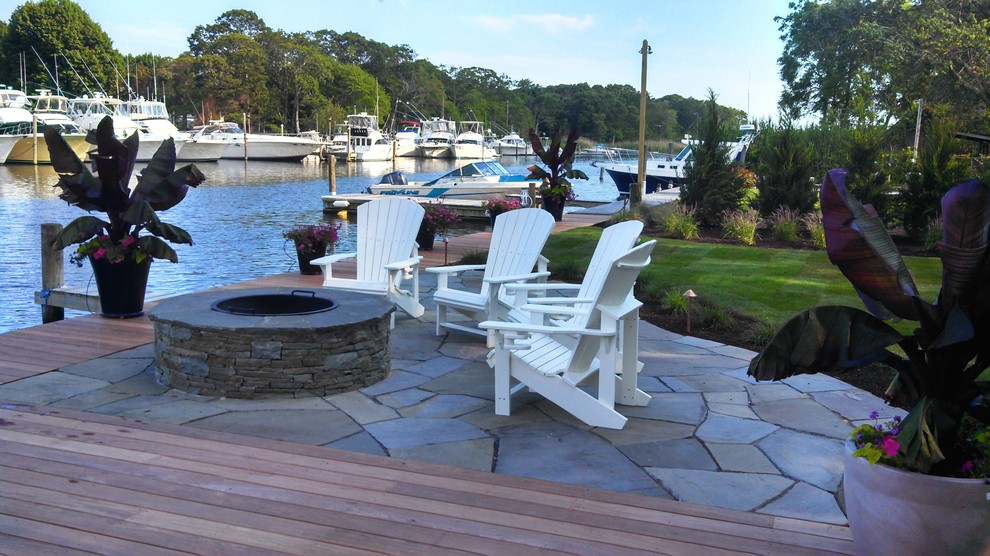 Patio - mid-sized coastal backyard stone patio idea in New York with a fire pit and no cover