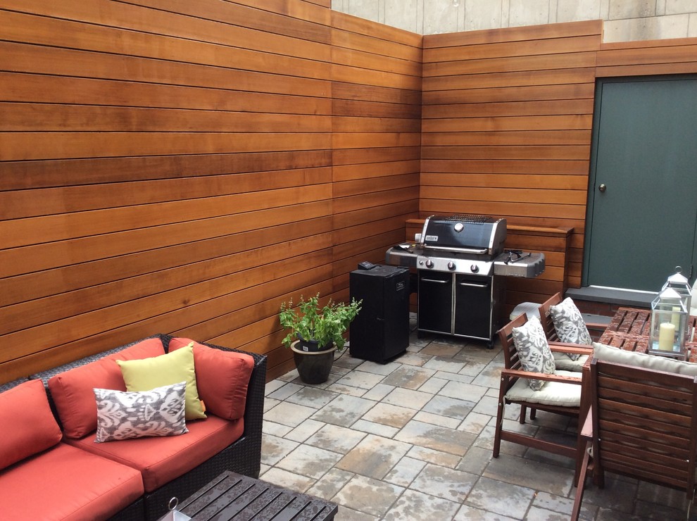 Small modern patio in Boston with concrete paving and no cover.