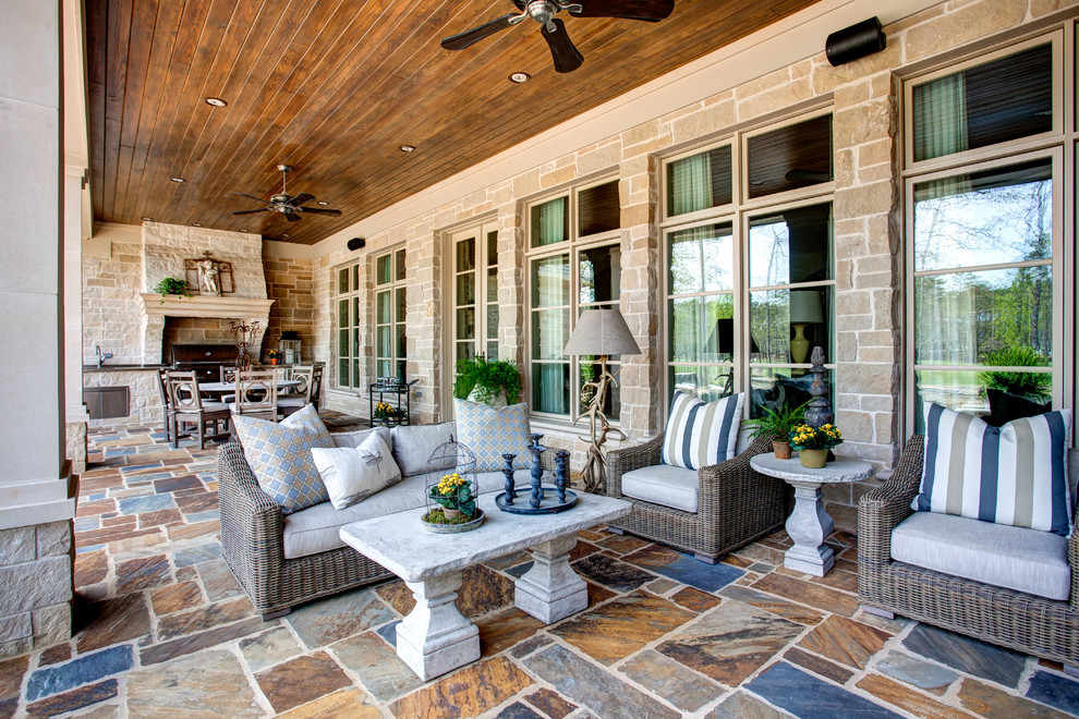 Foto de patio clásico extra grande en patio trasero y anexo de casas con adoquines de piedra natural