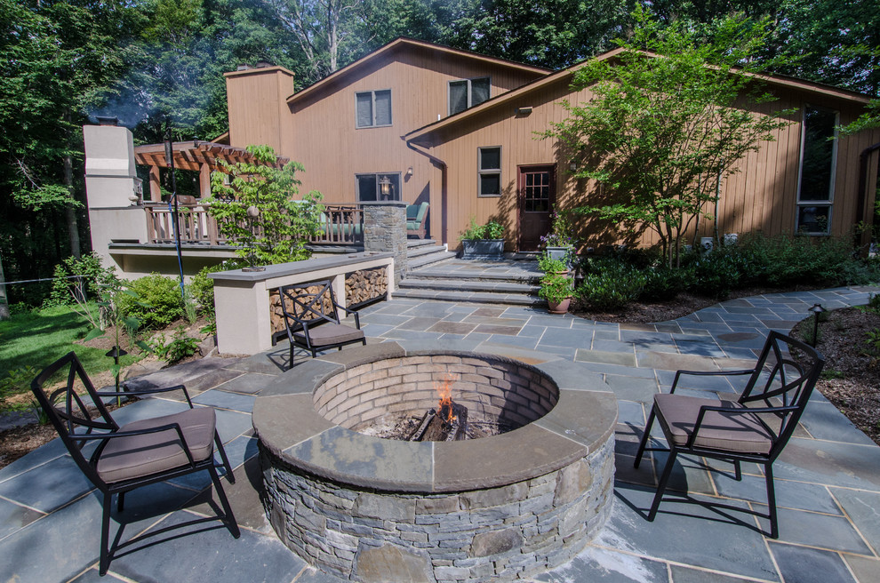 Design ideas for a large classic back patio in DC Metro with a fire feature, natural stone paving and a pergola.