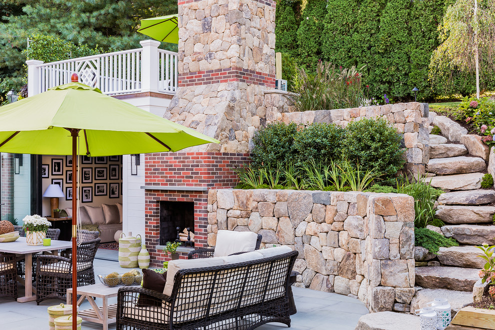 This is an example of a classic patio in Boston with a fireplace.