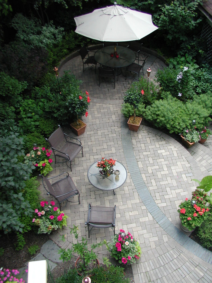 Example of a small trendy backyard brick patio container garden design in Chicago with no cover
