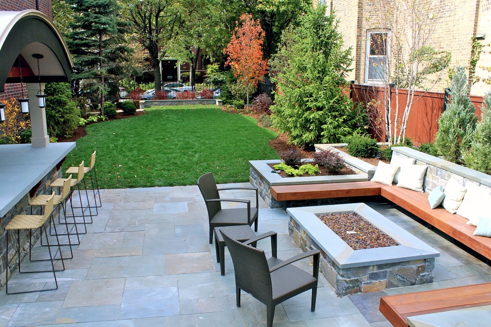 Example of a mid-sized trendy backyard stone patio design in Chicago with a fire pit and no cover