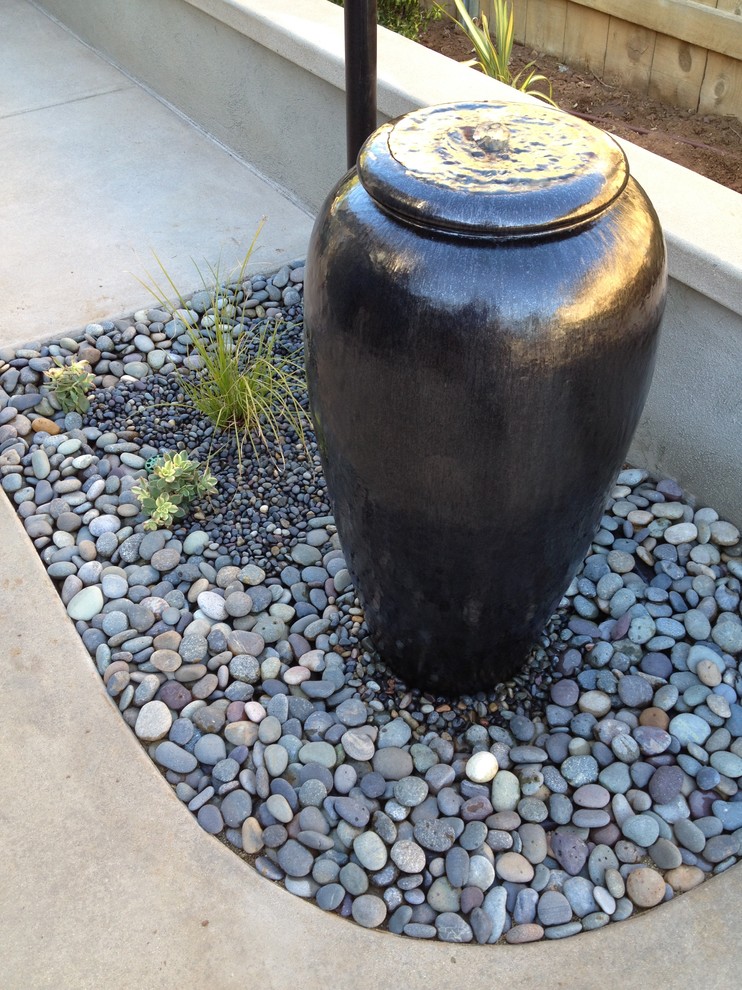 Mid-sized arts and crafts backyard concrete patio fountain photo in San Diego with a pergola