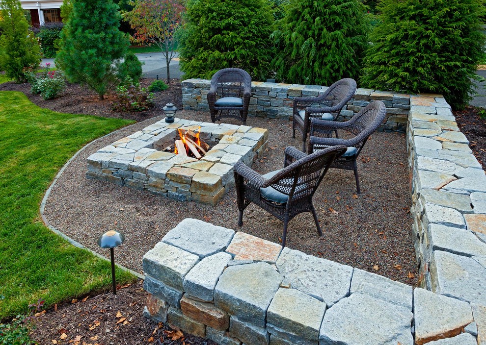 Photo of a medium sized traditional back patio in Other with a fire feature, natural stone paving and no cover.