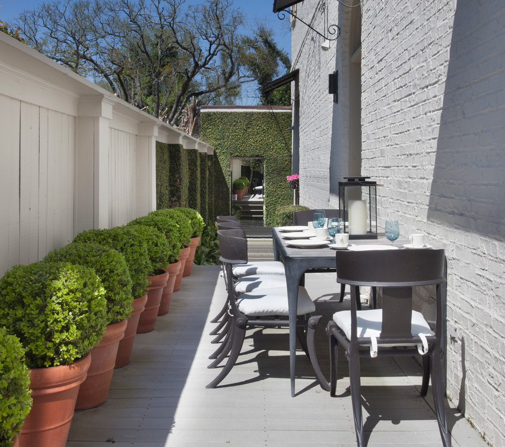 Elegant side yard patio photo in New Orleans with decking and no cover