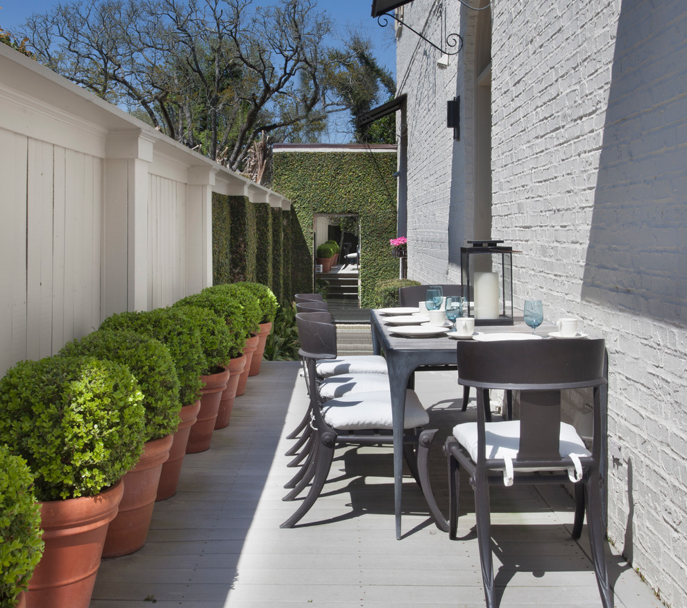 Elegant side yard patio container garden photo in New Orleans with decking and no cover