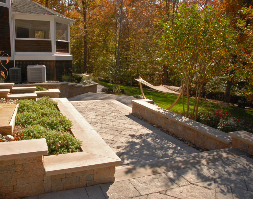 Design ideas for a medium sized contemporary side patio in DC Metro with concrete paving.