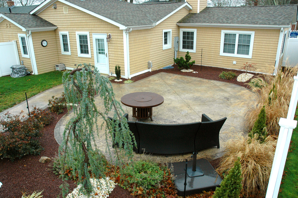 Patio - mid-sized backyard stamped concrete patio idea in Bridgeport with a fire pit
