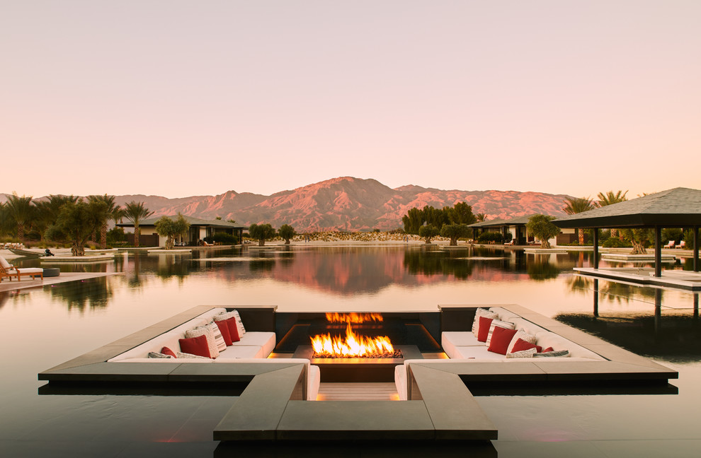 Patio - huge modern backyard patio idea in Other with a fire pit, decking and no cover