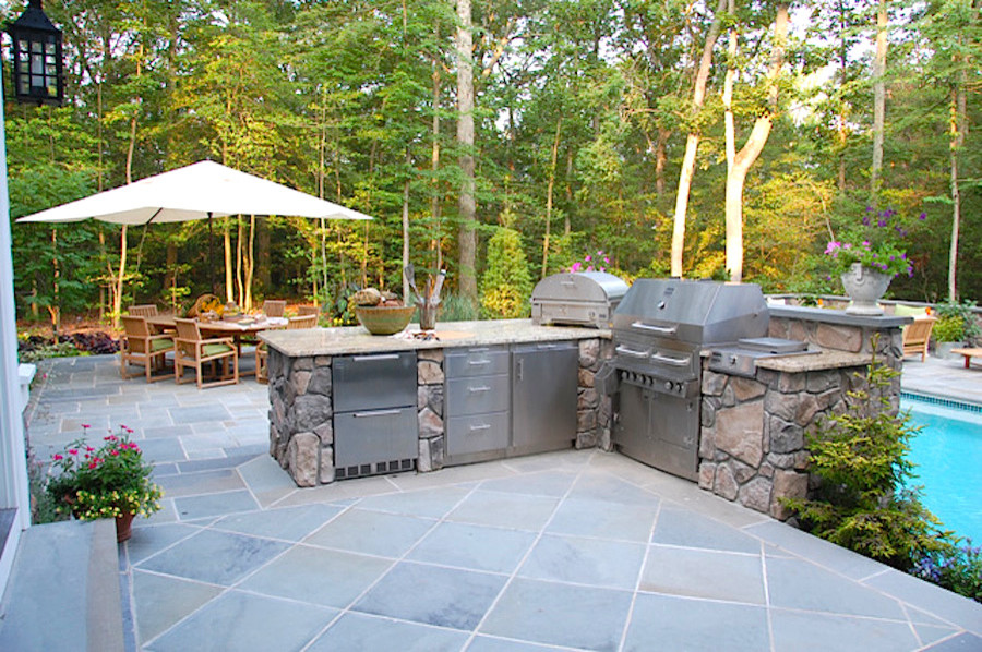 Inspiration for a large traditional back patio in Baltimore with an outdoor kitchen and natural stone paving.