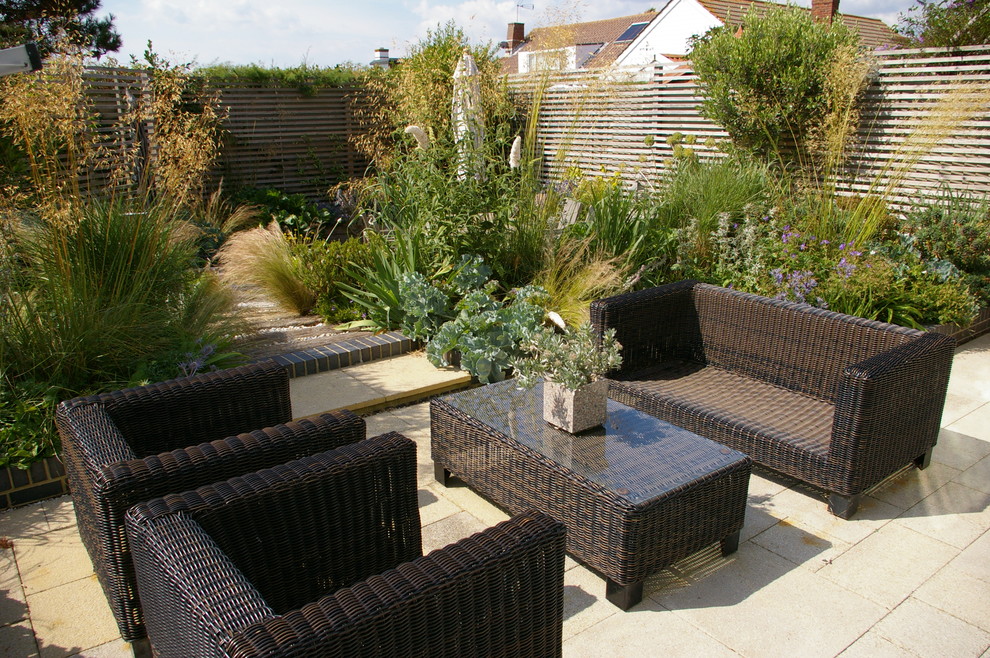 Example of a beach style patio design in Sussex