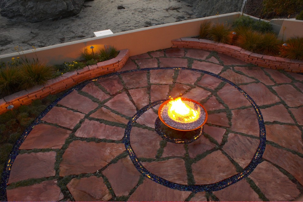 Example of a beach style patio design in San Luis Obispo with a fire pit