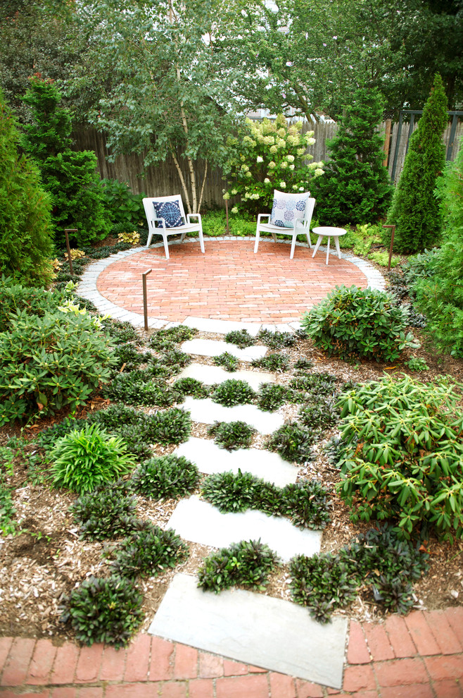 This is an example of a small classic back patio in Boston with brick paving.