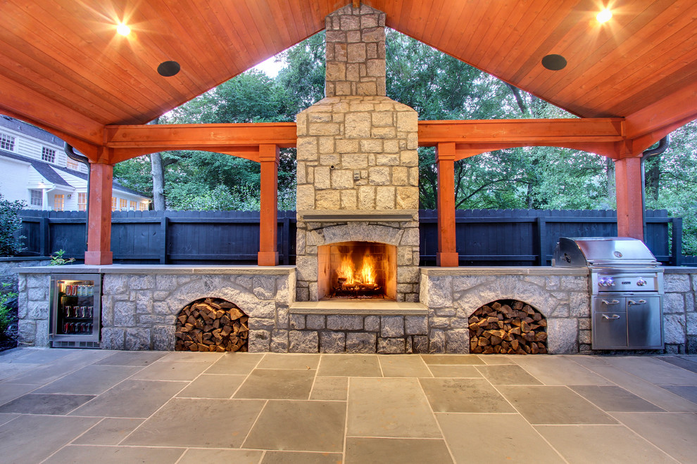 Photo of a medium sized contemporary back patio in Atlanta with natural stone paving, an outdoor kitchen and a gazebo.