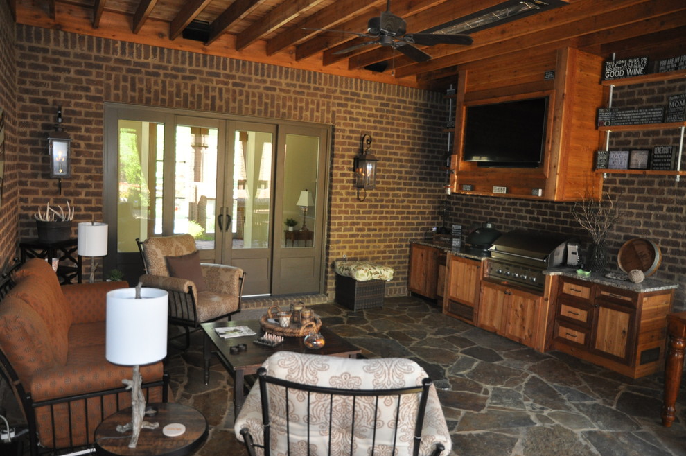 Photo of a medium sized classic back patio in Other with an outdoor kitchen, natural stone paving and a gazebo.