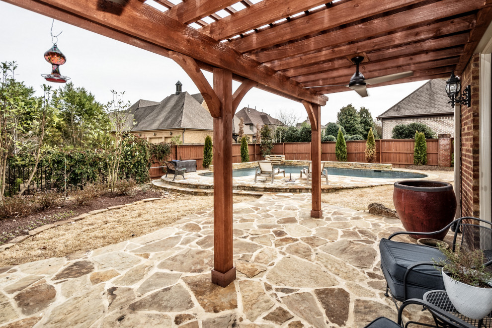 Example of a mid-sized classic backyard patio design in Other with a pergola