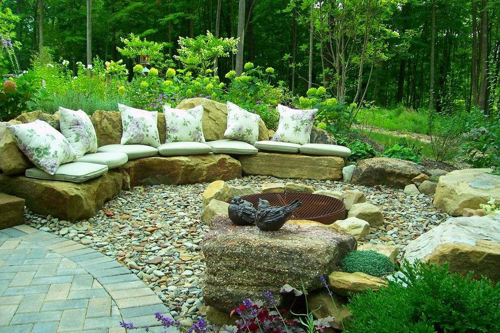 Inspiration for a large timeless backyard gravel patio remodel in Cleveland with a fire pit and no cover