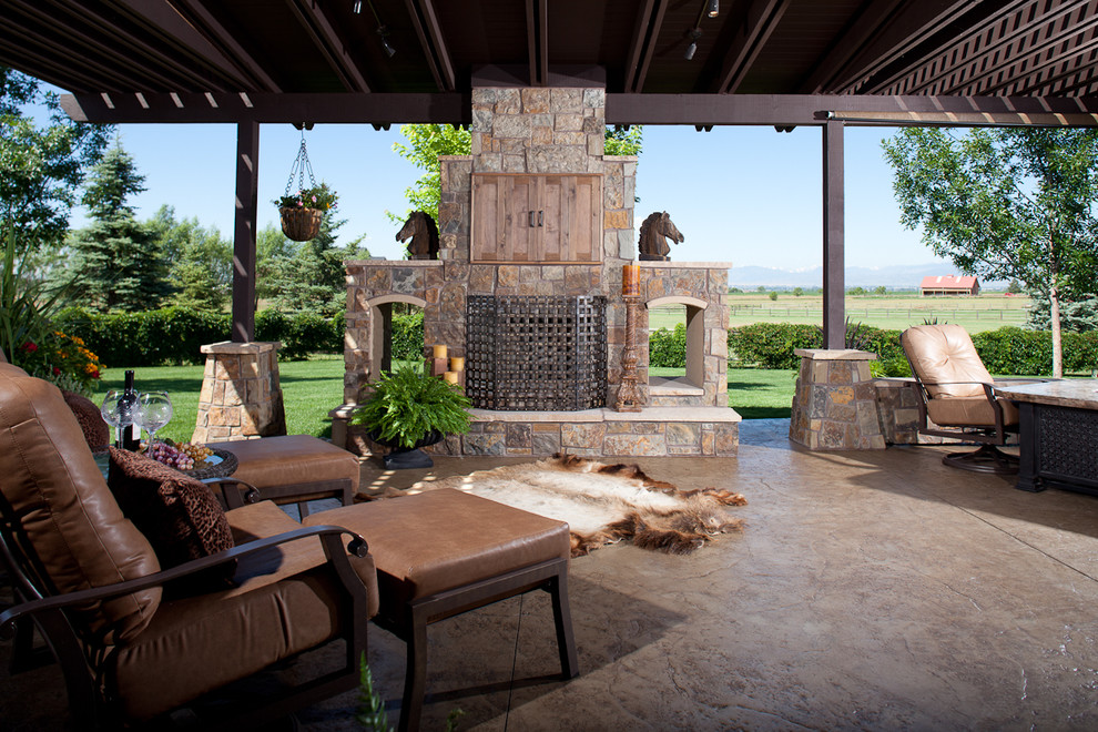 Traditional patio in Denver with a fire feature and a pergola.