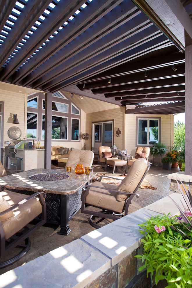 Photo of a traditional patio in Denver with a fire feature and a pergola.