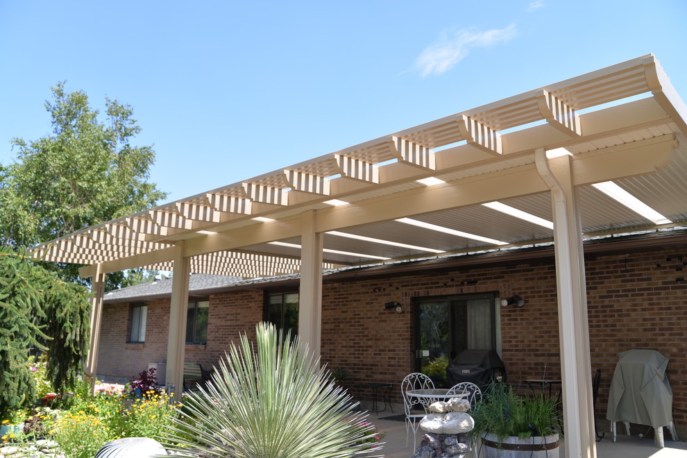 Photo of a large traditional back patio in Boise with an awning.