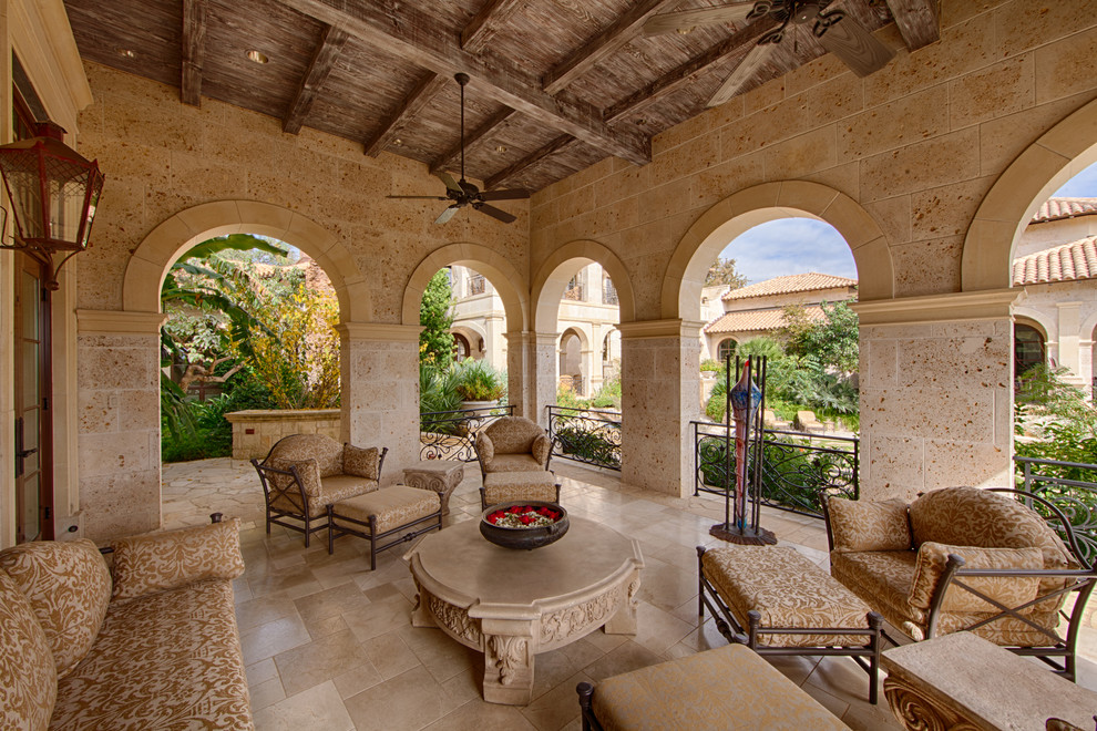 Mediterranean patio in Austin with tiled flooring and a roof extension.