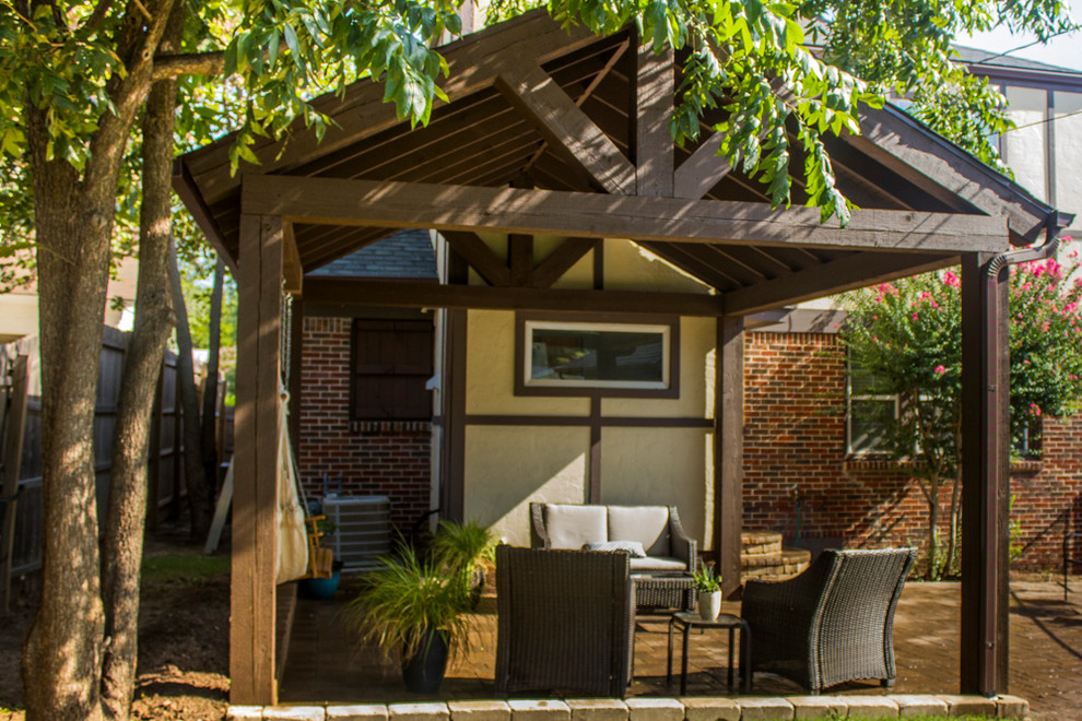 Small backyard brick patio photo in Oklahoma City with a pergola