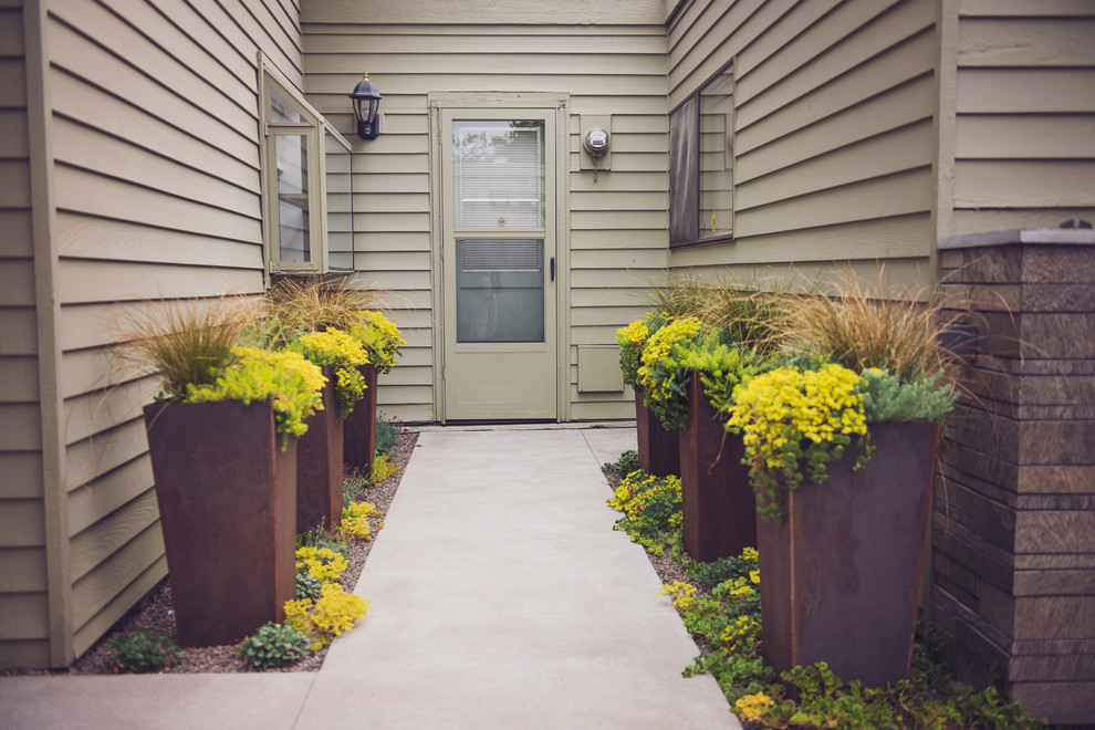 Compact Concrete Courtyard with CORTEN Planters Modern Patio