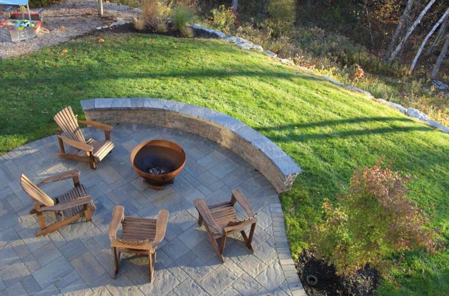 Example of a small trendy backyard concrete paver patio design in Manchester with a fire pit