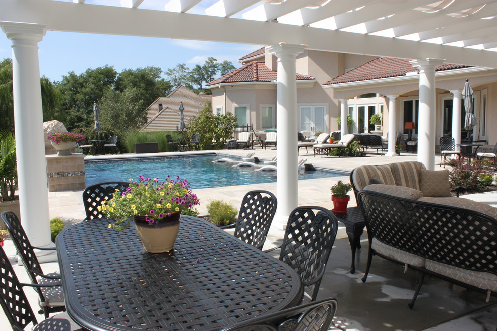 Expansive mediterranean back patio in Kansas City with an outdoor kitchen and a pergola.