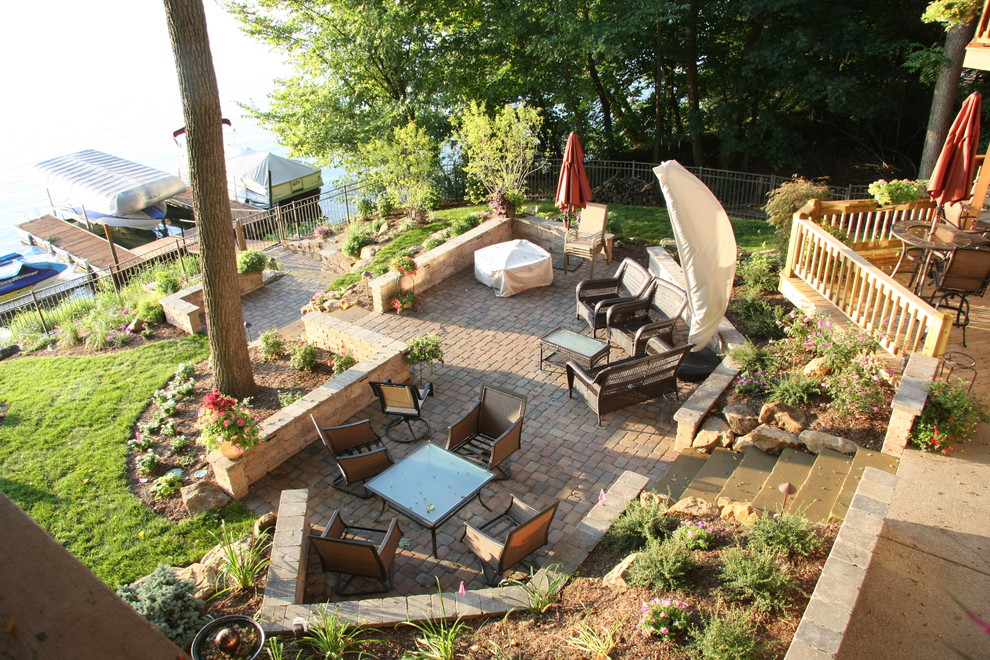 Modelo de patio tradicional extra grande en patio trasero con adoquines de hormigón