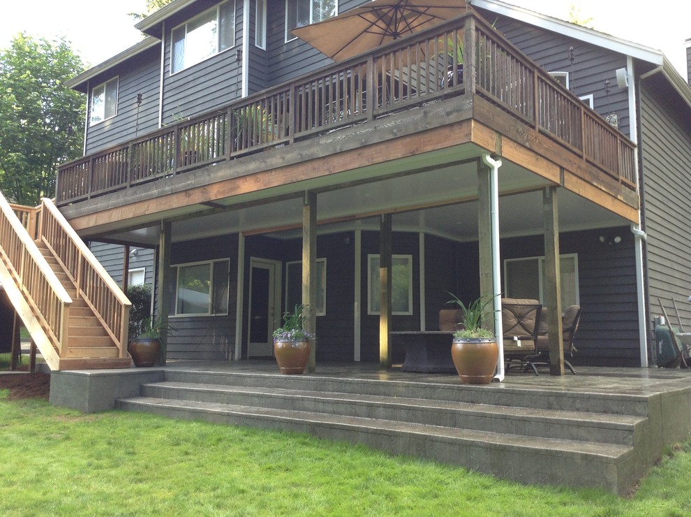 This is an example of a medium sized traditional back patio in Seattle with a fire feature and stamped concrete.