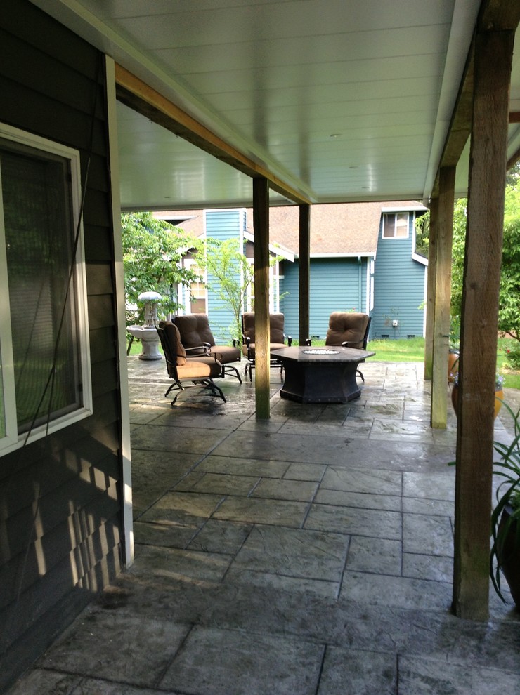 Design ideas for a medium sized classic back patio in Seattle with a fire feature and stamped concrete.