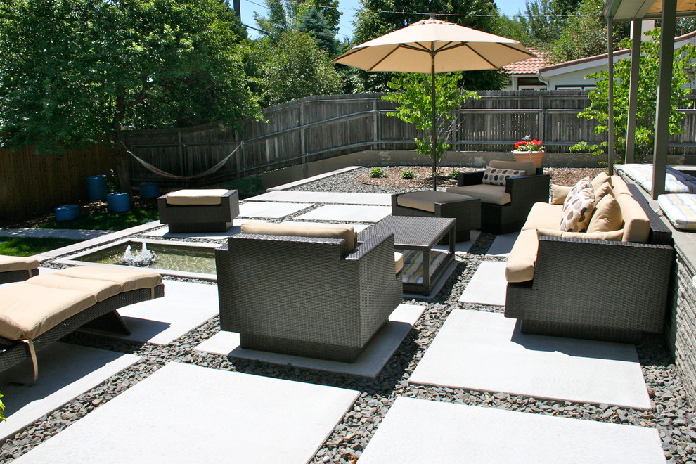 Inspiration for a contemporary patio in Denver with a water feature.