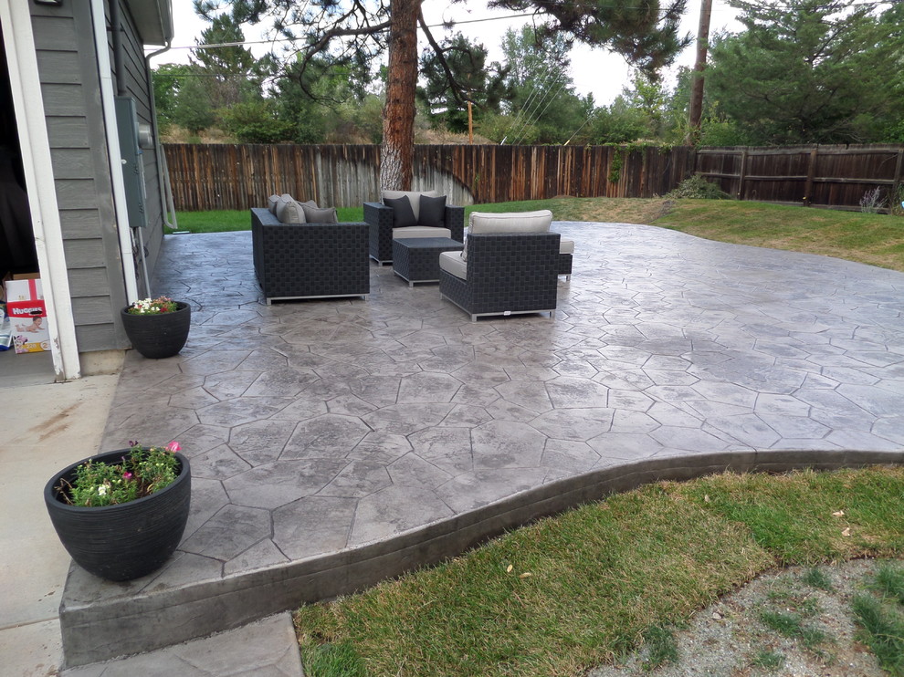 Design ideas for a medium sized modern back patio in Denver with stamped concrete and no cover.