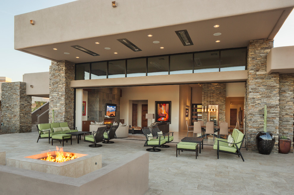 Patio - contemporary patio idea in Phoenix with a fire pit and a roof extension