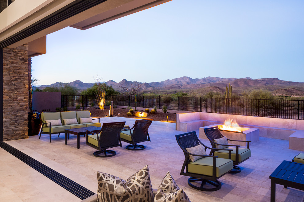 Inspiration for a contemporary patio remodel in Phoenix with a fire pit and a roof extension