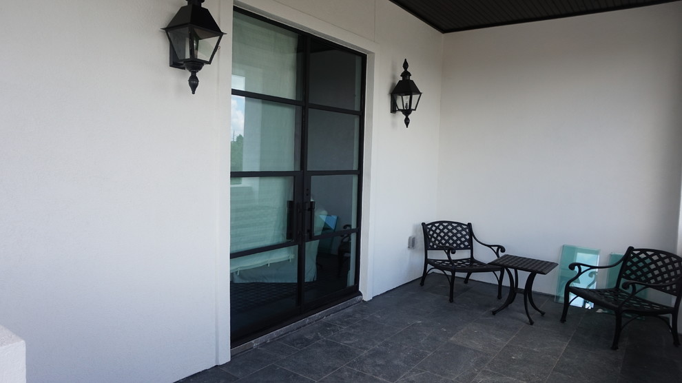Photo of a medium sized contemporary back patio in Houston with natural stone paving and no cover.