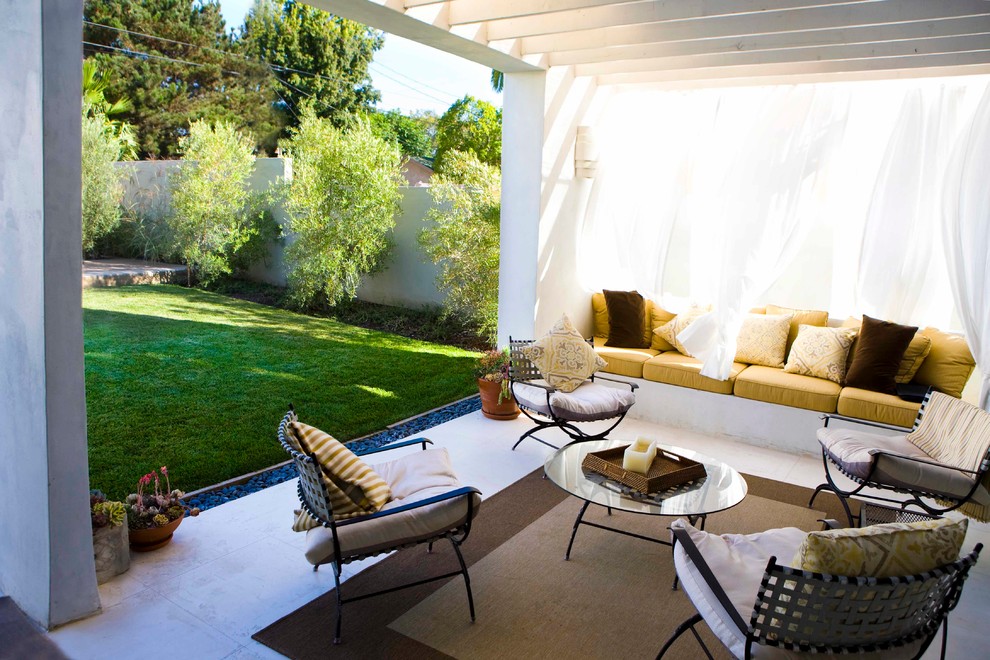 This is an example of a medium sized contemporary back patio in Los Angeles with tiled flooring and a pergola.