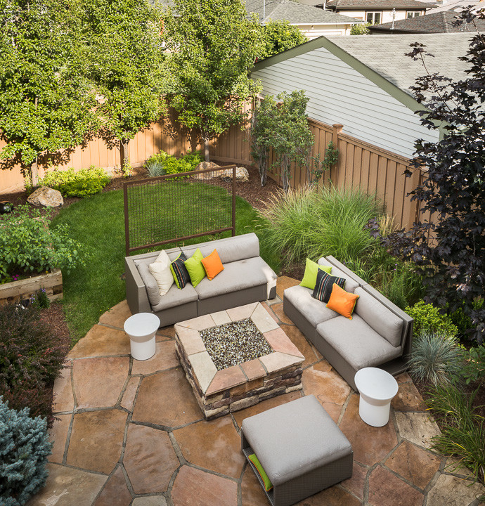 Inspiration for a large contemporary backyard stone patio remodel in Denver with a fire pit and no cover