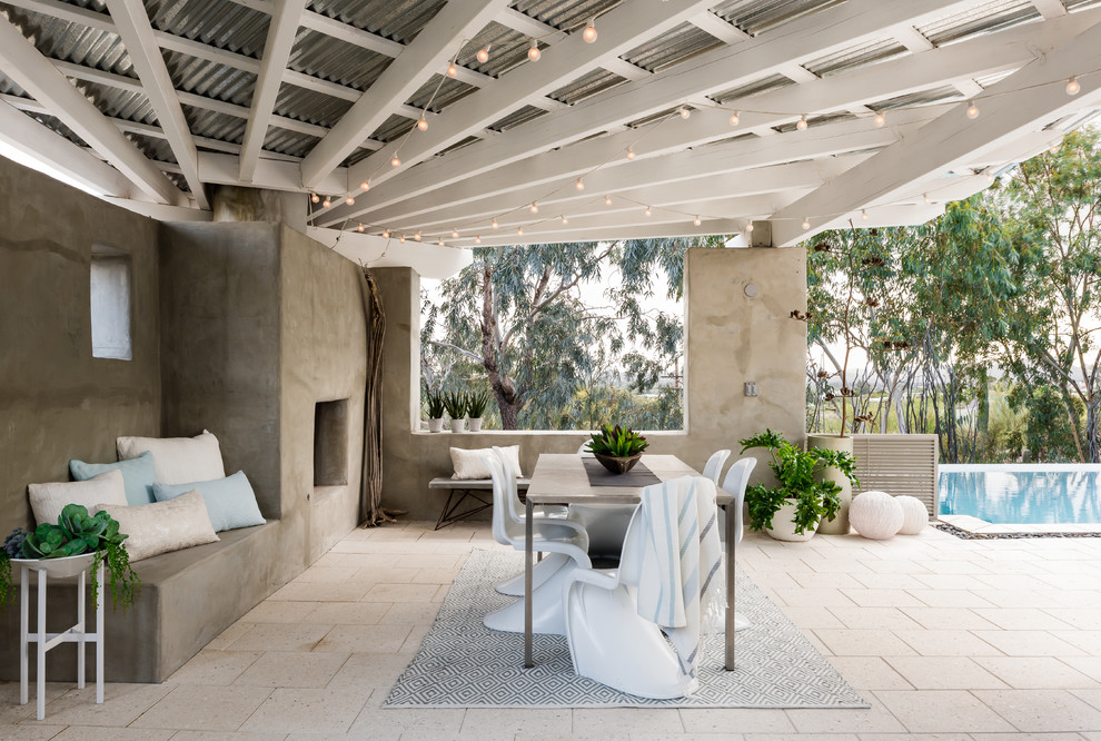 Inspiration for a mid-sized coastal backyard stone patio remodel in Phoenix with a gazebo and a fireplace