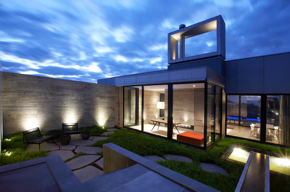 Contemporary patio in Melbourne with a water feature.