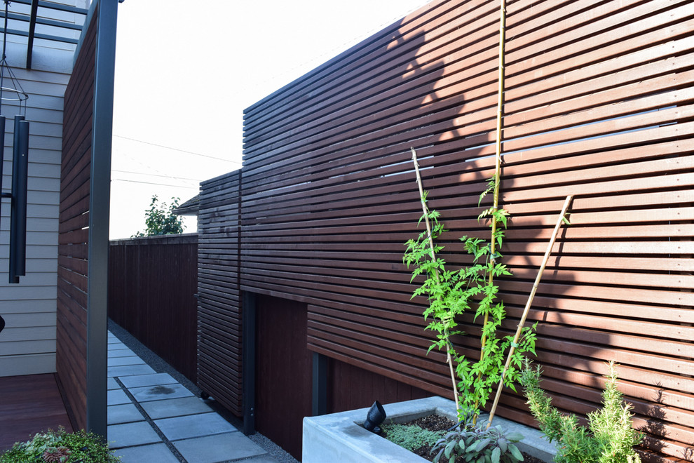 Inspiration for a small zen backyard concrete paver patio container garden remodel in Portland with a pergola