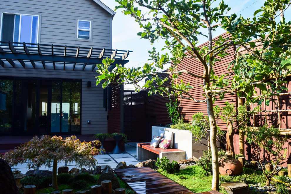 Patio container garden - small zen backyard concrete paver patio container garden idea in Portland with a pergola