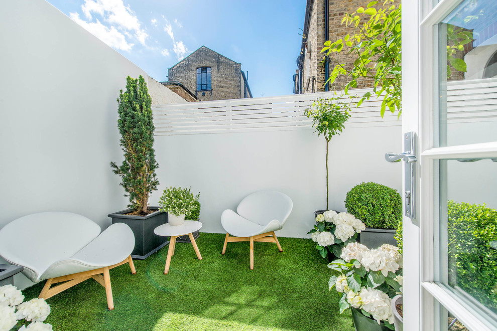 Design ideas for a small contemporary patio in London with fencing.
