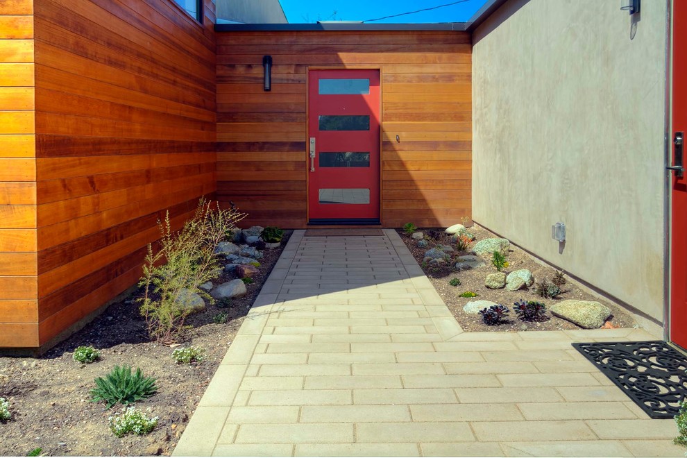 Immagine di un piccolo patio o portico design davanti casa con pavimentazioni in cemento