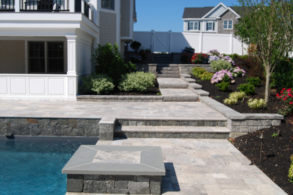 Inspiration for a mid-sized contemporary backyard stone patio remodel in Boston with no cover