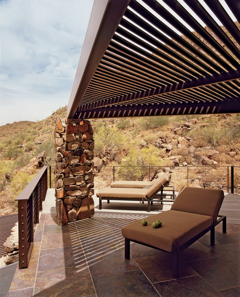 Design ideas for a contemporary side patio in Phoenix with tiled flooring and a pergola.