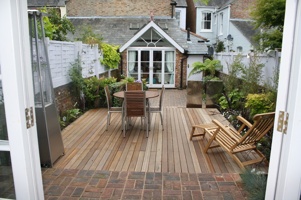 Design ideas for a contemporary patio in Sussex with a fire feature.